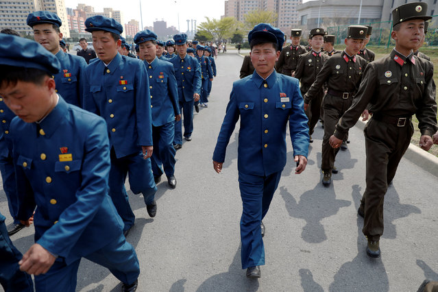 Soldiers and other uniformed people arrive to visit the flower exhibition marking the 105th birth anniversary of the country's founding father, Kim Il Sung in Pyongyang, North Korea April 16, 2017. (Photo by Damir Sagolj/Reuters)
