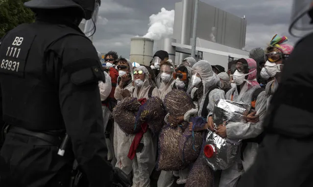 German riot police stand guard against anti-coal activists that entered the grounds of the coal mine company Vattenfall factory Schwarze Pumpe on May 14, 2016 near Spremberg, Germany. The activists, part of a movement called “Ende Gelaende”, are demanding an end to the use of coal for energy production in favor of renewable energy means. The Welzow Sued mine is operated by Vattenfall but is in the process of being sold to the Czech energy company EPH. (Photo by Carsten Koall/Getty Images)