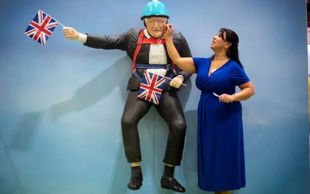 Cake maker Rosie Dummer makes the final touches to a life-sized Boris Johnson cake at the Cake and Bake Show at ExCeL in London, England on October 4, 2019. (Photo by Victoria Jones/PA Images via Getty Images)