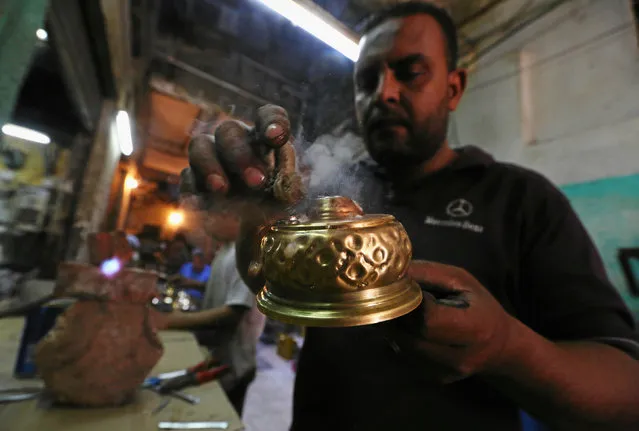 Abdel Nasser, son of workshop owner Mohamed Gamal Abdel Nasser, manfactures primus stoves known as “Bagour” in Arabic, in Cairo, Egypt, May 11, 2016. (Photo by Mohamed Abd El Ghany/Reuters)