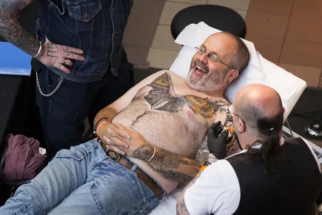 A man gets tattooed at The Great British Tattoo Show at Alexandra Palace on May 24, 2014 in London, England. (Photo by Tristan Fewings/Getty Images for Alexandra Palace)