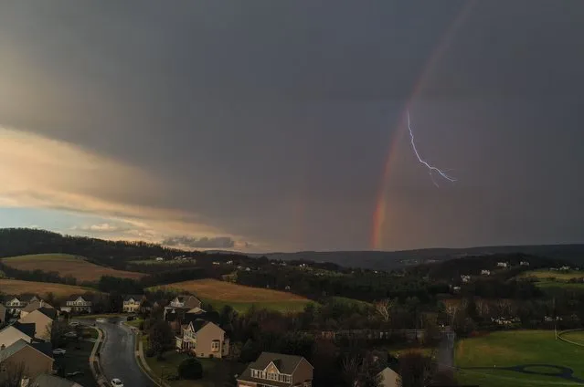 A lightning strike appears through a rainbow after heavy thunderstorms on March 31, 2022 in Myersville, Md. (Photo by Ricky Carioti/The Washington Post)