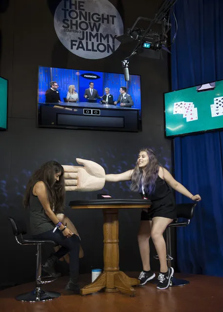 Brenda Duron, right, 16, and her cousin Kimberly Duron, 21, both of Los Angeles, Calif., play Slap Jack at the NBC booth featuring “The Tonight Show Starring Jimmy Fallon”, during the 6th annual VidCon at Anaheim Convention Center on Thursday, July 23, 2015, in Anaheim, Calif. The online video event runs July 23-25. (Photo by Ed Crisostomo/The Orange County Register via AP Photo)