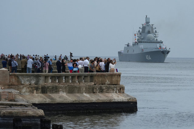 People watch Russian frigate Admiral Gorshkov as it enters Havana’s bay, Cuba, on June 12, 2024. (Photo by Alexandre Meneghini/Reuters)