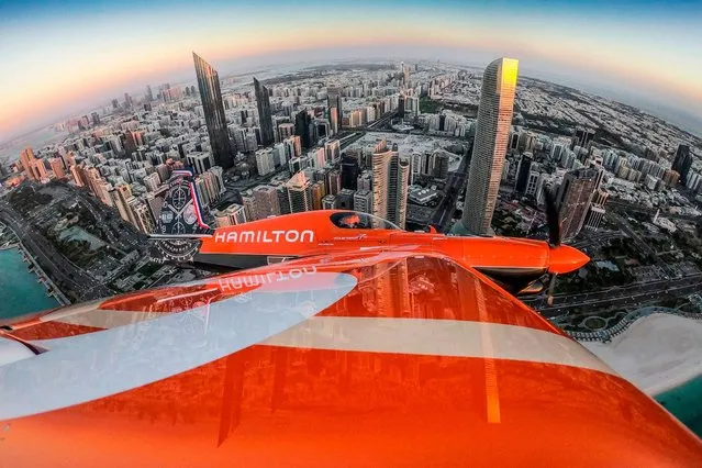 This handout photograph taken and released by Limex Images for Red Bull on February 6, 2019 shows France's Nicolas Ivanoff flying over the skyline prior to the first stage of the Red Bull Air Race World Championship in Abu Dhabi, United Arab Emirates. (Photo by Predrag Vuckovic/AFP Photo)