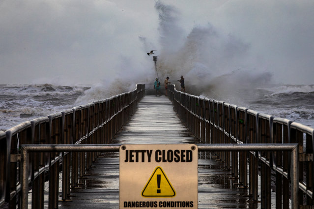 Fishermen from Orange Grove fish off the Packery Channel Jetty amid large swells from Tropical Storm Beryl in Corpus Christi, Texas, U.S. July 7, 2024. (Photo by Angela Piazza/Caller-Times/USA Today Network via Reuters)