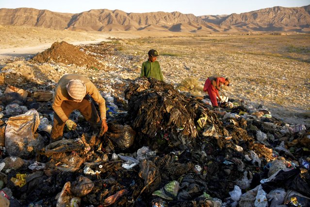 Afghan boys search for recyclable materials at a garbage dump on the outskirts of Mazar-i- Sharif on July 25, 2024. (Photo by Atif Aryan/AFP Photo)