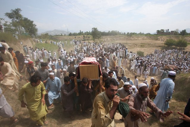 People carry the coffins of victims, who were killed in a blast, during funeral in Bajaur district of Khyber Pakhtunkhwa province, Pakistan on July 31, 2023. (Photo by Khuram Parvez/Reuters)