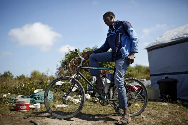 Abdou Al Hammoud from Sudan stands with his bicycle at “The New Jungle” camp in Calais, France, August 8, 2015. (Photo by Juan Medina/Reuters)