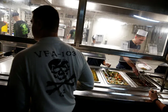 A US Navy sailor queues for food on board the USS Harry S. Truman aircraft carrier in the eastern Mediterranean Sea, June 14, 2016. (Photo by Baz Ratner/Reuters)