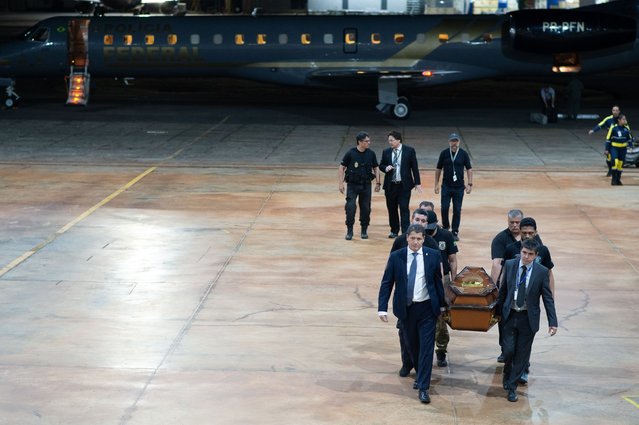 Members of the Brazilian police transport the casket carrying the recovered human remains from believed to be assassinated Indigenous affairs expert Bruno Pereira of Brazil and freelance reporter Dom Phillips of Great Britain as they arrive to Federal Police hangar at Juscelino Kubitschek International Airport on June 16, 2022 in Brasilia, Brazil. Phillips and Pereira, who were conducting research for a book on conservation efforts, both went missing on June 5 during a trip in the Javari Valley, in the far western part of the Amazonas state. On Wednesday 15, one of the suspects detained by the police admitted killing the pair. (Photo by Andressa Anholete/Getty Images)