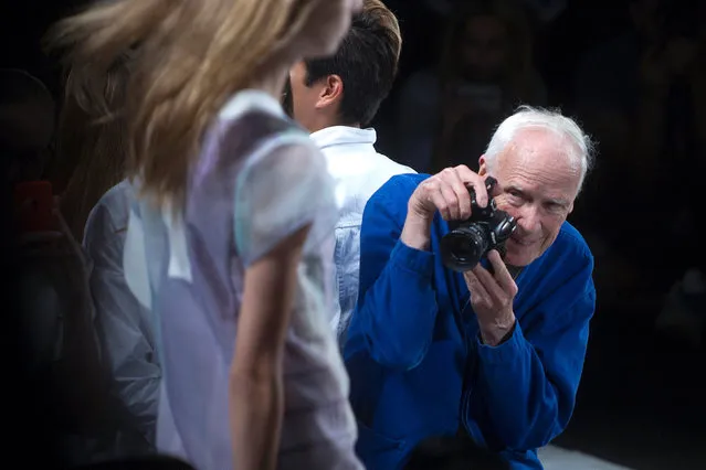 New York Times photographer Bill Cunningham takes photos as a model presents a creation from the Lacoste Spring/Summer 2015 collection during New York Fashion Week in the Manhattan borough of New York September 6, 2014. Cunningham, a longtime fashion photographer for The New York Times known for taking pictures of everyday people on the streets in New York died on Saturday, June 25, 2016, after suffering a stroke in New York. He was 87. (Photo by Carlo Allegri/Reuters)