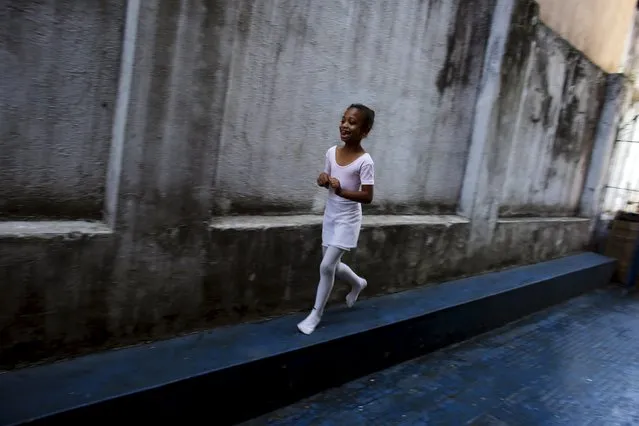 Thalita Jesus, 7,  runs inside her house before her ballet lesson at the New Dreams dance studio, in the Luz neighborhood known to locals as Cracolandia (Crackland) in Sao Paulo, Brazil, August 12, 2015. (Photo by Nacho Doce/Reuters)