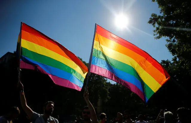 Revellers wave flags during a gay pride parade in downtown Madrid, Spain, July 2, 2016. (Photo by Andrea Comas/Reuters)