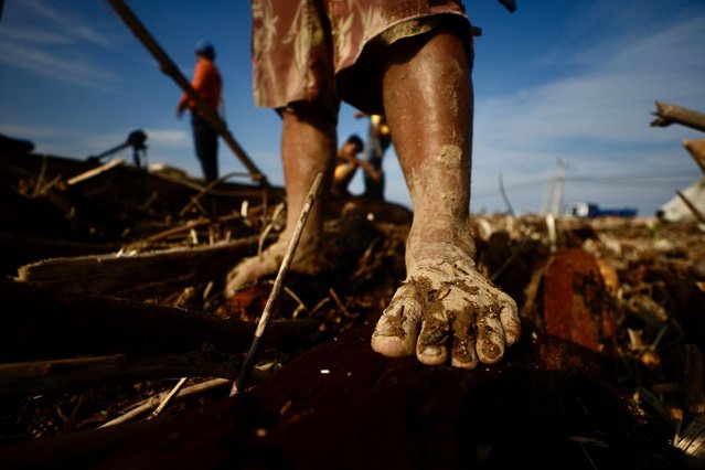 A Filipino villager walks amongst debris and logs caused by Typhoon Usagi in the coastal municipality of Santa Ana, Cagayan province, Philippines, 15 November 2024. (Photo by Francis R. Malasig/EPA/EFE)