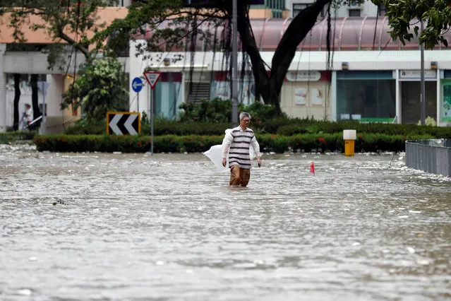 A man walks through a flooded street as Typhoon Hato hits Hong Kong, China on August 23, 2017. (Photo by Tyrone Siu/Reuters)