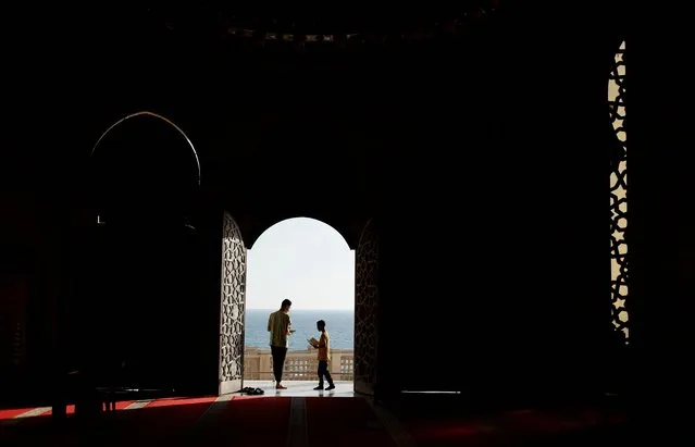 Palestinians stand outside the door of a mosque in Gaza City on June 8, 2022. (Photo by Mohammed Salem/Reuters)