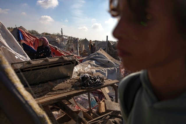 Palestinians inspect the damage following Israeli shelling at a camp housing internally displaced people in Khan Younis, southern Gaza Strip, 13 November 2024. More than 43,700 Palestinians and over 1,400 Israelis have been killed, according to the Palestinian Health Ministry and the Israeli Army, since Hamas militants launched an attack against Israel from the Gaza Strip on 07 October 2023, and the Israeli operations in Gaza and the West Bank which followed it. (Photo by Haitham Imad/EPA/EFE)