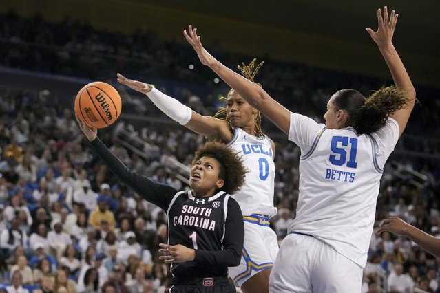 South Carolina guard Maddy McDaniel (1) drives to the basket against UCLA forward Janiah Barker (0) and center Lauren Betts (51) during the first half of an NCAA college basketball game, Sunday, November 24, 2024, in Los Angeles. (Photo by Eric Thayer/AP Photo)
