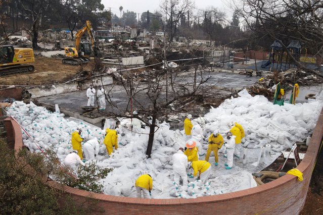 A drone view shows workers in protective suits collecting burnt asbestos from the Eaton fire at a destroyed school, Loma Alta Elementary School in Altadena, California, U.S. February 5, 2025. (Photo by David Swanson/Reuters)