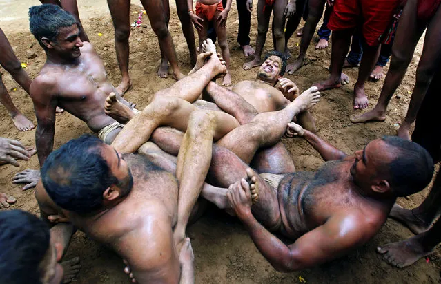 Wrestlers practice at a traditional Indian wrestling training centre in Allahabad, India, August 7, 2016. (Photo by Jitendra Prakash/Reuters)