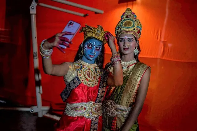 Artists take a selfie before going on stage for a Ramleela performance as part of Dussehra festival celebrations in New Delhi, India, Tuesday, October 4, 2022. (Photo by Altaf Qadri/AP Photo)