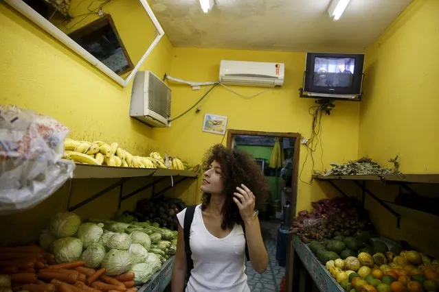 Syrian Tulin Hashemi shops for fruit at a market in Vidigal slum in Rio de Janeiro, Brazil, September 22, 2015. (Photo by Pilar Olivares/Reuters)