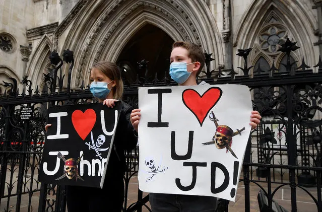 Fans of actor Johnny Depp hold placards as they wait for him to arrive at the High Court, in London, Britain on July 15, 2020. (Photo by Toby Melville/Reuters)