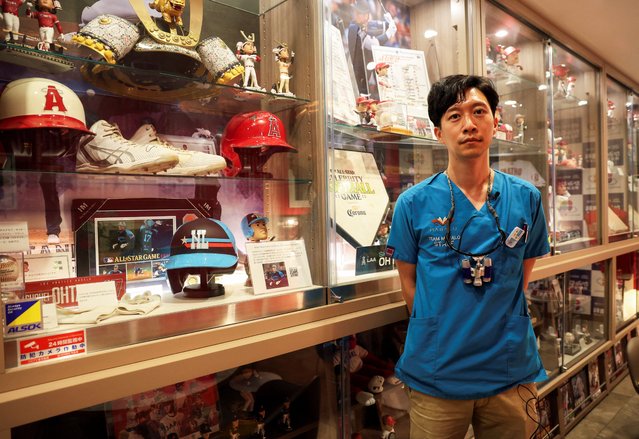 Japanese dentist Yusuke Kamimura poses for a photograph in front of a private collections dedicated to Major League Baseball player Shohei Ohtani, inside his Kamimura dental clinic in Koshigaya, north of Tokyo, Japan on February 28, 2025. (Photo by Irene Wang/Reuters)