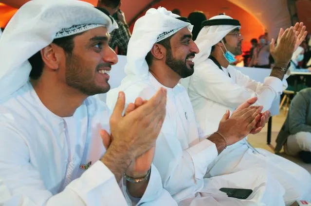 Emirati men claps as they watch the launch of the “Amal” or “Hope” space probe at the Mohammed bin Rashid Space Center in Dubai, United Arab Emirates, Monday, July 20, 2020. A United Arab Emirates spacecraft, the “Amal” or “Hope” probe, blasted off to Mars from Japan early Monday, starting the Arab world's first interplanetary trip. (Photo by Jon Gambrell/AP Photo)