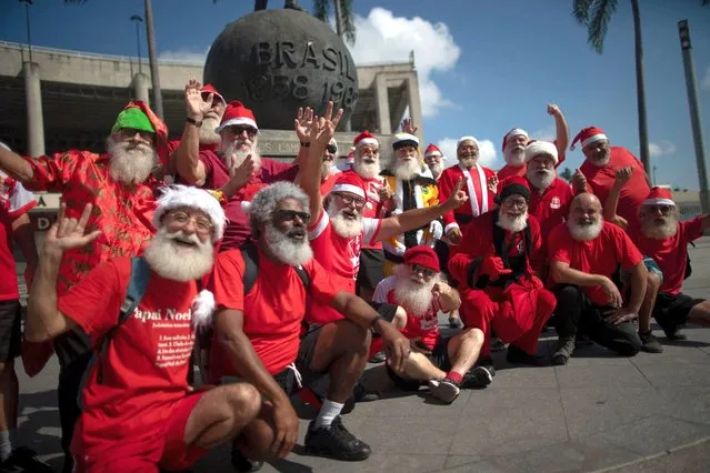 Graduates from Brazil's School of Santa Claus pose for a picture outside the Maracana stadium after the graduation ceremony in Rio de Janeiro on October 26, 2022. Most of the students are learning this new profession as an option to look for jobs during Christmas season. (Photo by Mauro Pimentel/AFP Photo)