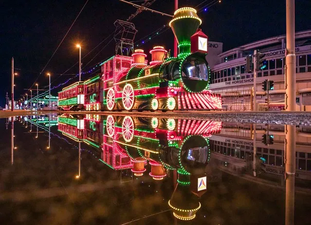 Picture dated September 7th, 2022 shows the lights of the Blackpool Illuminations reflected in the puddles after storms hit the region. Further showers and thunderstorms are expected in the south of England, with an increasing risk of heavy rain across northeast England and eastern Scotland later. (Photo by Gregg Wolstenholme/Bav Media)