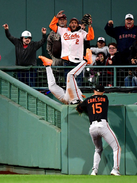 Baltimore Orioles centerfield Jorge Mateo (3) flips into the bullpen after a home run hit by Boston Red Sox first baseman Abraham Toro (29) (not pictured) while right fielder Dylan Carlson (15) looks on during the ninth inning at Fenway Park in Boston, Massachusetts on May 24, 2025. (Photo by Bob DeChiara/Reuters)