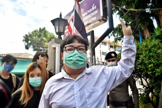 Activist Parit “Penguin” Chiwarak gives the three-fingered “Hunger Games” salute, a symbol of resistance, as he arrives at the Nangloeng police station in Bangkok, Thailand, Tuesday, Aug, 25, 2020. Four prominent Thai anti-government activists, including Parit, answered a summons at a Bangkok police station on Tuesday, the latest in a series of legal moves by the authorities to clamp down on protests that are the most serious challenge yet to Prime Minister Prayuth Chan-ocha's administration. (Photo by Lillian Suwanrumpha/AFP Photo)