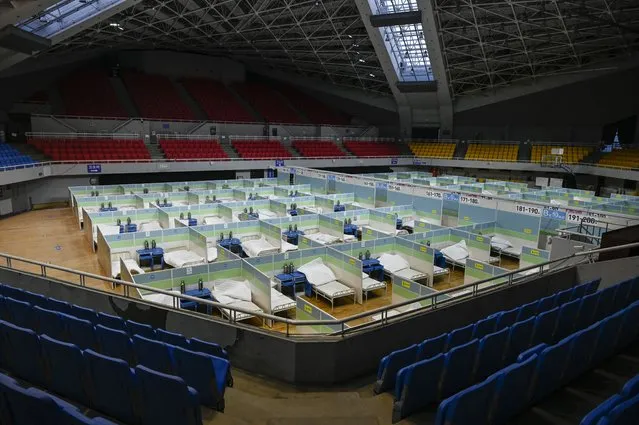 Beds for patients are seen in partitioned rooms at a makeshift fever clinic at a stadium amid the Covid-19 pandemic in Beijing on December 20, 2022. (Photo by Jade Gao/AFP Photo)