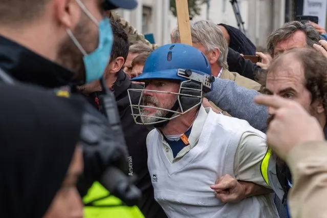 Protesters clash with police officers during a “We Do Not Consent” anti-mask rally at Trafalgar Square on September 26, 2020 in London, England. (Photo by London News Pictures/The Sun)