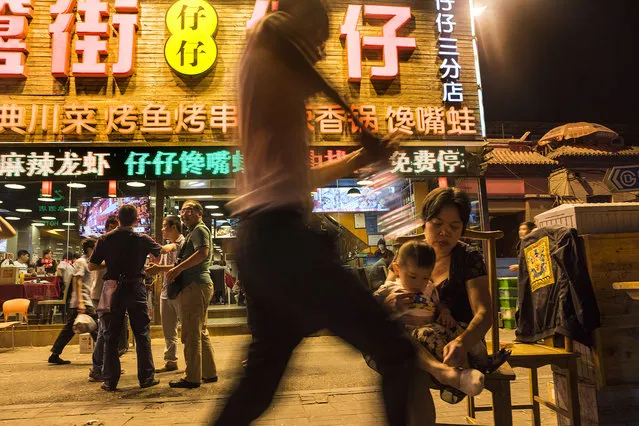 Diners, families and tourists all mingle along Beijing's famous “Ghost Street” on May 26, 2016. The city is in a rapid state of development as it tries to remain as economically vital as Shanghai and Guangzhou. (Photo by Michael Robinson Chavez/The Washington Post)