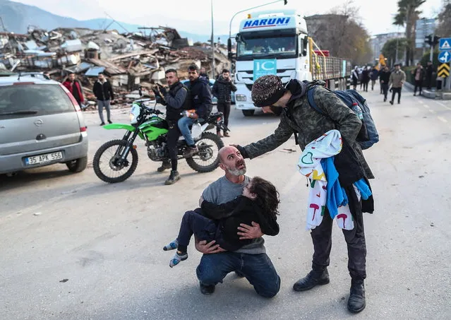  A man carries a girl who was rescued from the rubble of a collapsed building in Hatay, Turkey, 07 February 2023. Thousands of people died thousands more were injured after major earthquakes struck southern Turkey and northern Syria on 06 February. Authorities fear the death toll will keep climbing as rescuers look for survivors across the region. (Photo by Erdem Sahin/EPA)