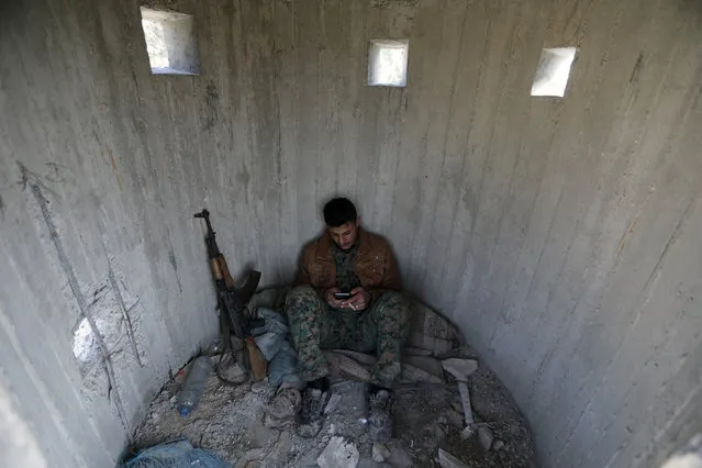 A Turkish-backed Free Syrian Army fighter rests at mount Bafliyun, in the Afrin region, Syria March 5, 2018. (Photo by Khalil Ashawi/Reuters)