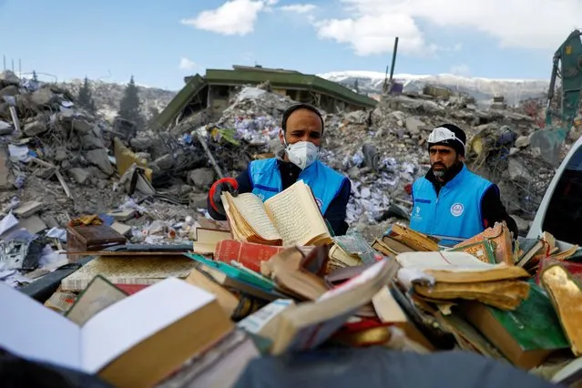 People collect copies of the Koran and Gospels from the rubble, in the aftermath of a deadly earthquake in Kahramanmaras, Turkey on February 15, 2023. (Photo by Suhaib Salem/Reuters)