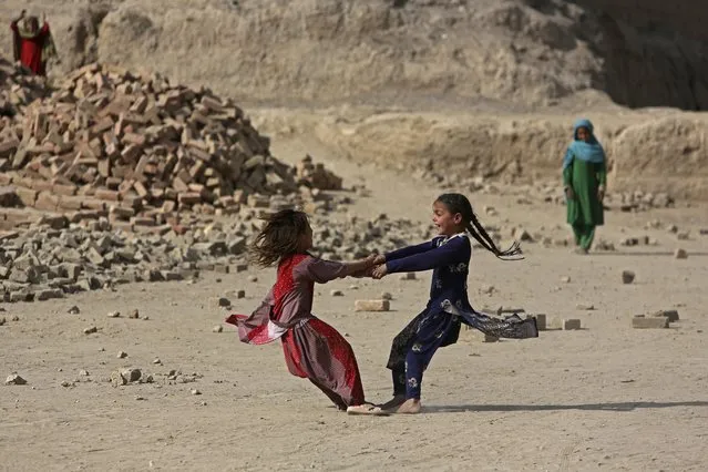 Afghan girls play on the outskirts of Kabul, Afghanistan, Tuesday, October 4, 2016, (Photo by Rahmat Gul/AP Photo)