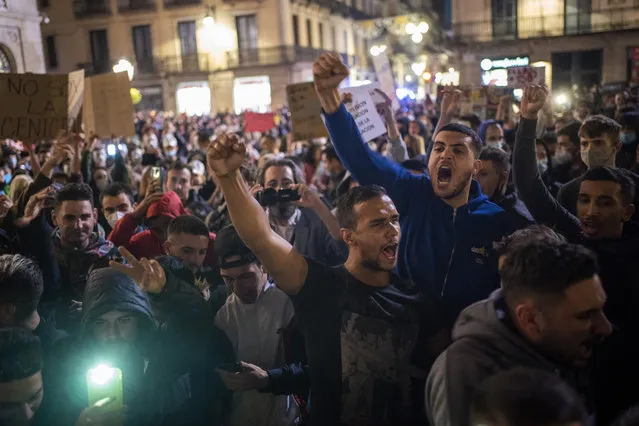 Demonstrators shout slogans agains the government before clashing with police in downtown Barcelona, Spain, Friday, October 30, 2020. (Photo by Emilio Morenatti/AP Photo)