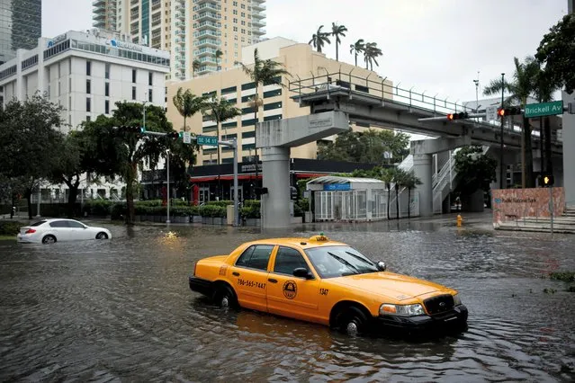 A damaged taxi is seen in floodwaters caused by Tropical Storm Eta in a street at the Brickell neighborhood in Miami, Florida, U.S., November 9, 2020. (Photo by Marco Bello/Reuters)