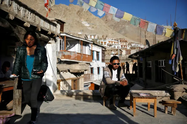 Travel agent, Stanton Othsil, 29, sits in the sun in Leh, the largest town in the region of Ladakh, nestled high in the Indian Himalayas, India September 29, 2016. When asked how living in the world's fastest growing major economy had affected life, Othsil said: “More tourists are coming now, especially Indians who are spending more money”. (Photo by Cathal McNaughton/Reuters)