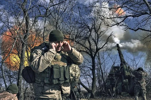 Ukrainian soldiers fire a self-propelled howitzer towards Russian positions near Bakhmut, Donetsk region, Ukraine, Sunday, March 5, 2023. (Photo by Libkos/AP Photo)