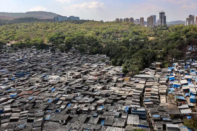 The slums in Malad east area, near the forest land of Sanjay Gandhi National Park, in Mumbai, India, 22 April 2023. World Earth Day is marked annually on 22 April, a date created by the United Nations to raise awareness among the population about the values of biodiversity conservation and the problem of pollution. (Photo by Divyakant Solanki/EPA)