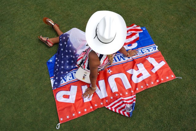 A supporter waits for the start of Republican presidential candidate former President Donald Trump's campaign rally in Doral, Fla., July 9, 2024. (Photo by Rebecca Blackwell/AP Photo)
