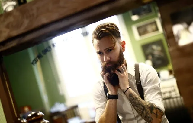 Alex “Torreto” Vellios, a 26-year old barber looks after his own beard as he waits for his first customer of the day at his Torreto barber shop in Frankfurt January 6, 2015. (Photo by Kai Pfaffenbach/Reuters)