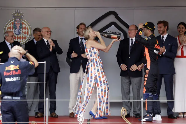Princess Charlene of Monaco drinking champagne on the podium after Red Bull driver Daniel Ricciardo of Australia winning the Formula One race, at the Monaco racetrack, in Monaco, Sunday, May 27, 2018. (Photo by Luca Bruno/AP Photo)