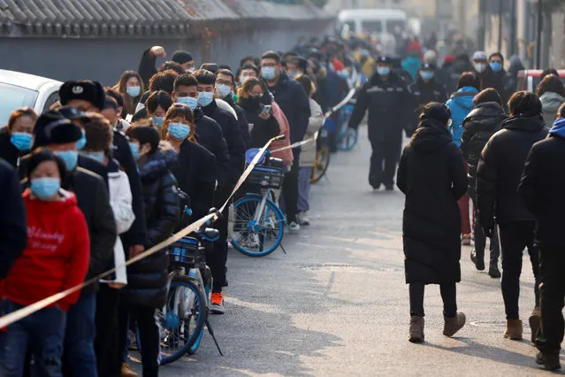 People line up to get their nucleic acid test following the outbreak of the coronavirus disease (COVID-19) in Beijing, China on January 22, 2021. (Photo by Carlos Garcia Rawlins/Reuters)